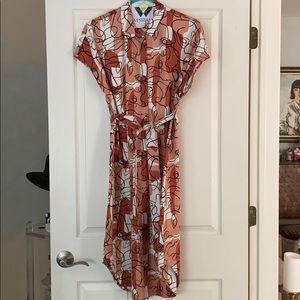 Terra cotta button down dress with line work faces
